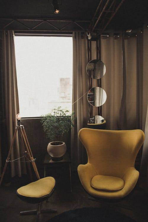 ellow Chair Near Three Round Mirrors